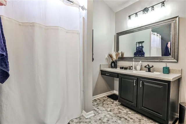 a bathroom with a double vanity sink and mirror