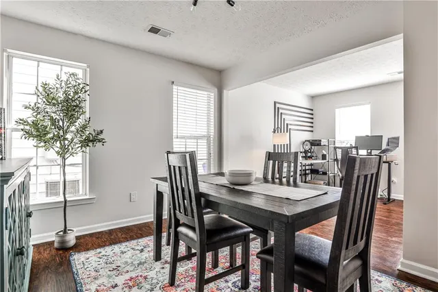 a view of a dining room with furniture and window