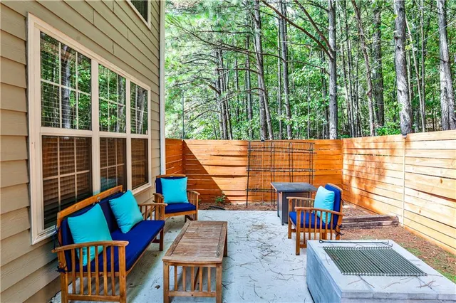a view of a house with a patio and a back yard