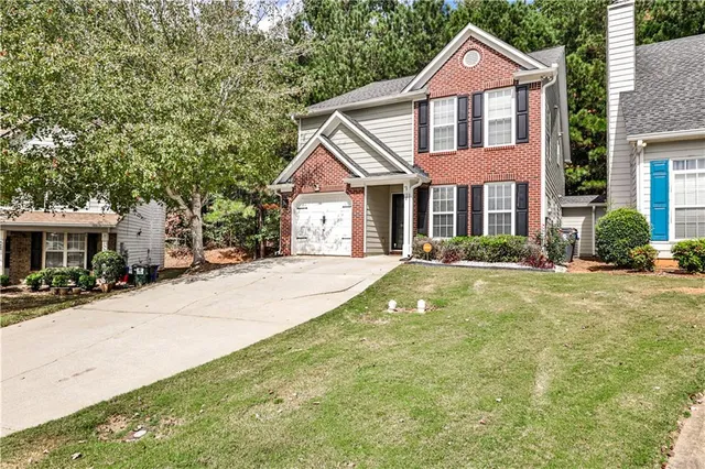a front view of a house with a yard