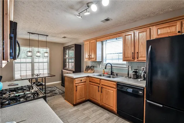 a kitchen with a sink stove and refrigerator