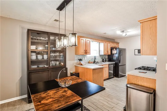 a kitchen with granite countertop lots of counter top space and stainless steel appliances