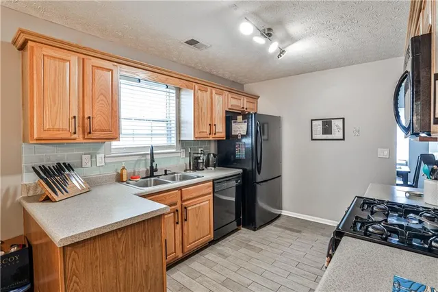 a kitchen that has a sink and a stove
