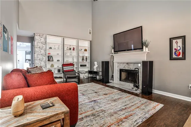 a living room with furniture a flat screen tv and a fireplace