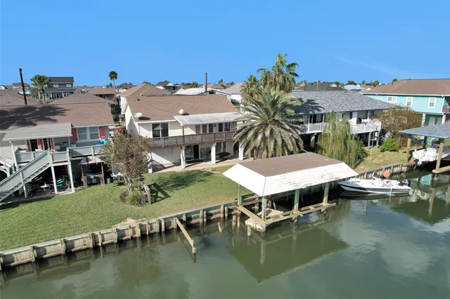 a aerial view of a house with swimming pool and a yard