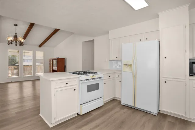 a kitchen with a stove a sink and a refrigerator