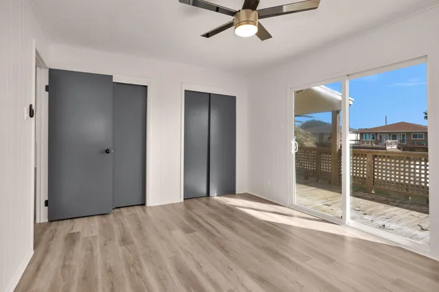 a view of a room with wooden floor and window