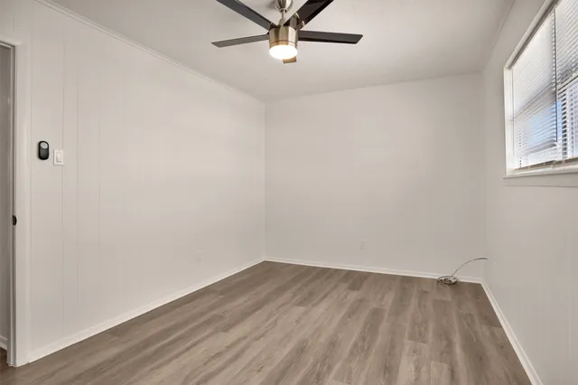 a view of a room with wooden floor and a window