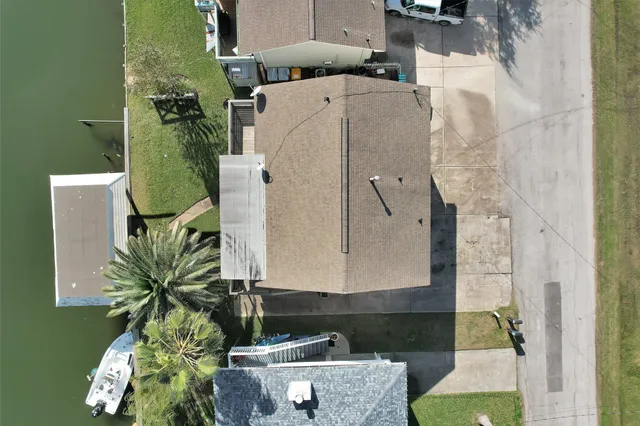 an aerial view of a house with a yard