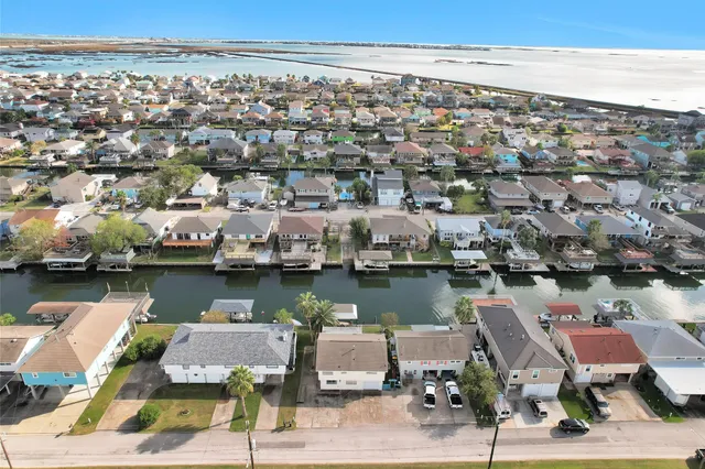 an aerial view of a houses with ocean view