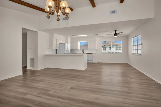 a view of a kitchen with a dishwasher cabinets and wooden floor