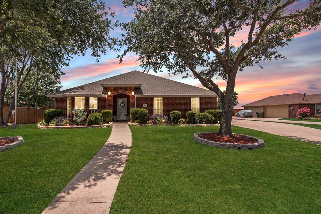 1409 Rodeo Drive Murphy, TX 75094 - Photo 1 of 1 a front view of a house with a yard