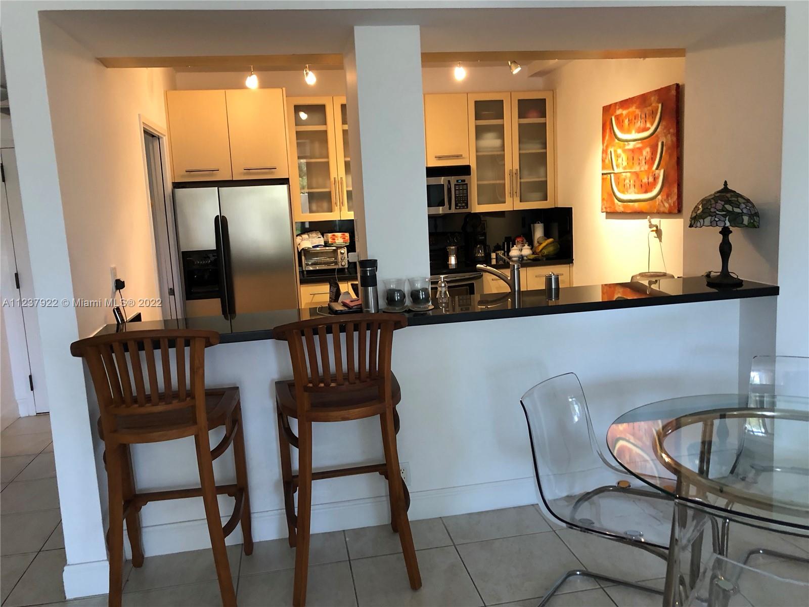 151 Crandon Boulevard, Unit 127 Key Biscayne, FL 33149 - Photo 15 of 30 a view of a dining room with furniture