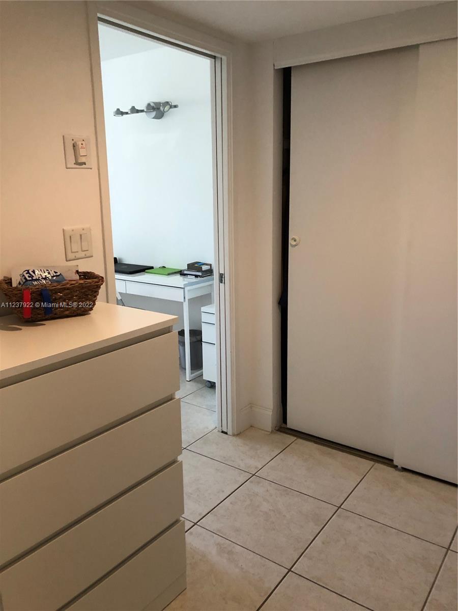 151 Crandon Boulevard, Unit 127 Key Biscayne, FL 33149 - Photo 20 of 30 a room with a stove and a table