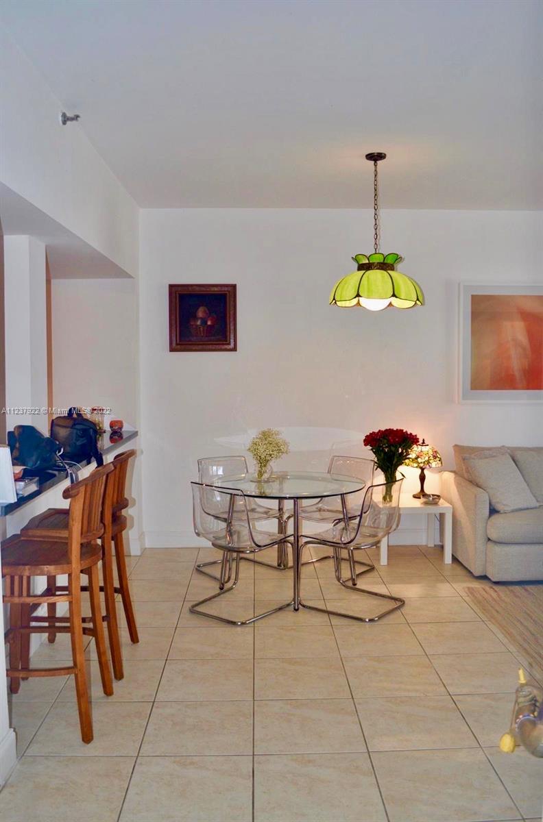 151 Crandon Boulevard, Unit 127 Key Biscayne, FL 33149 - Photo 9 of 30 a view of a dining room with furniture
