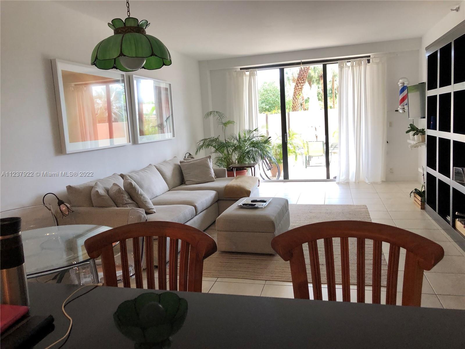 151 Crandon Boulevard, Unit 127 Key Biscayne, FL 33149 - Photo 10 of 30 a living room with furniture and a floor to ceiling window