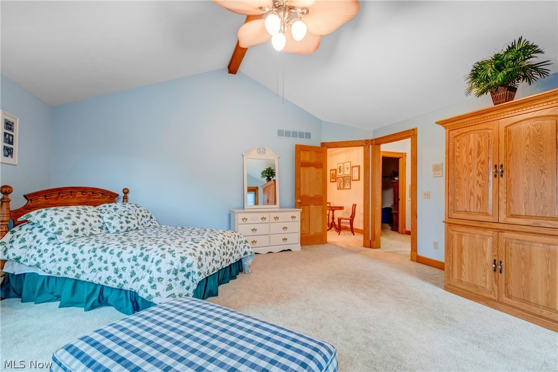 2645 Frost Road Mantua, OH 44255 - Photo 19 of 35 Sizable Primary Suite Vaulted ceiling ceiling fan carpet (hardwood) ornamental molding enough space for sofa