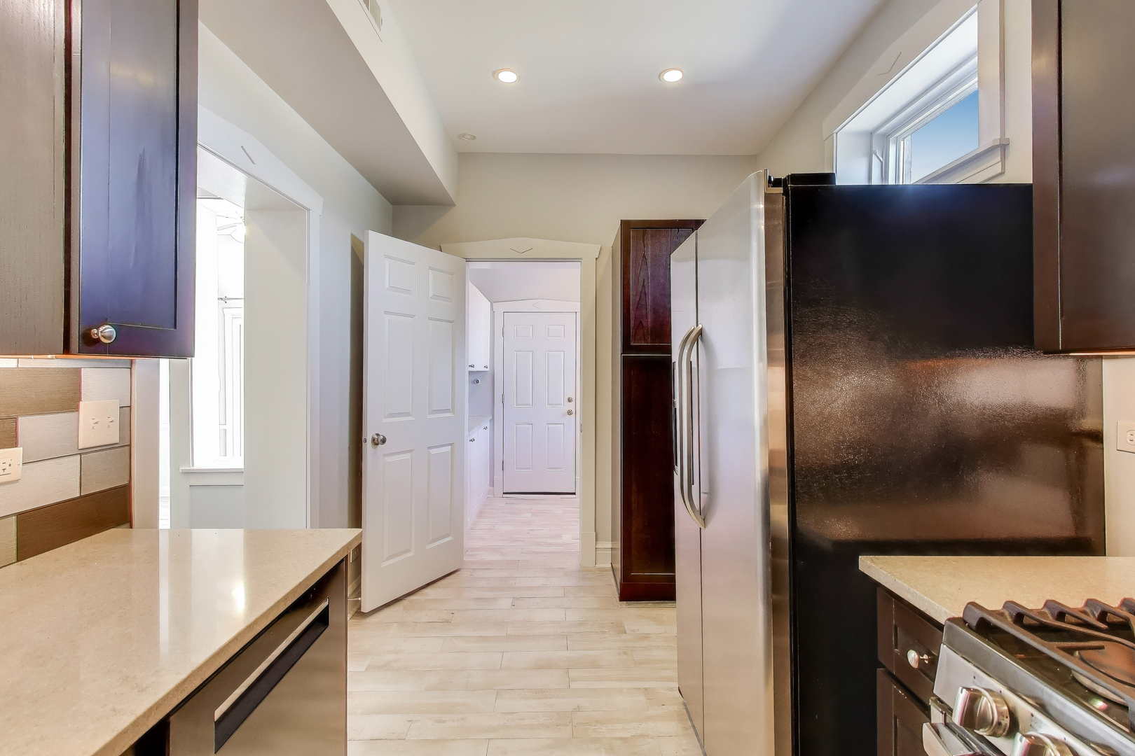 1447 West Warner Avenue, Unit 3W Chicago, IL 60613 - Photo 11 of 27 a kitchen with stainless steel appliances granite countertop a refrigerator and a stove