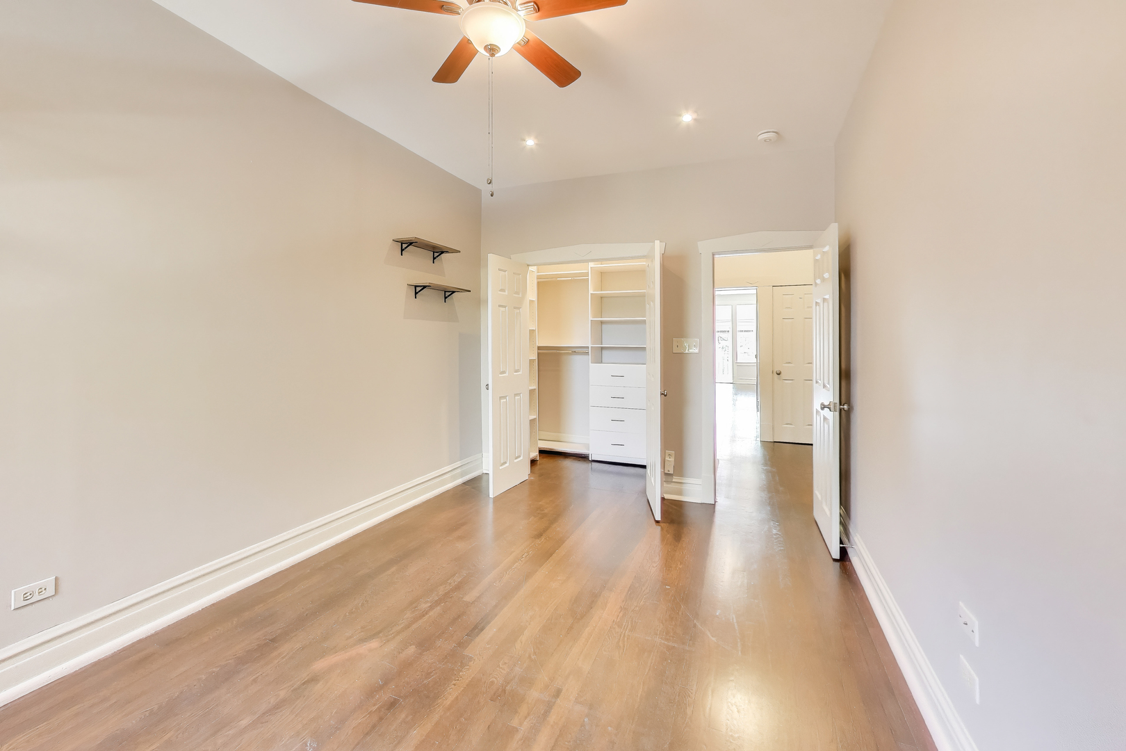 1447 West Warner Avenue, Unit 3W Chicago, IL 60613 - Photo 17 of 27 wooden floor in an empty room with a window