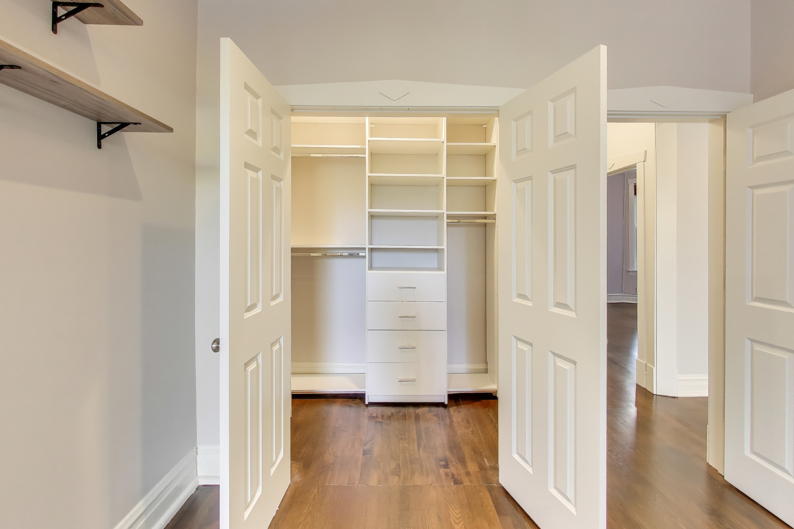1447 West Warner Avenue, Unit 3W Chicago, IL 60613 - Photo 19 of 27 a view of walk in closet with empty racks