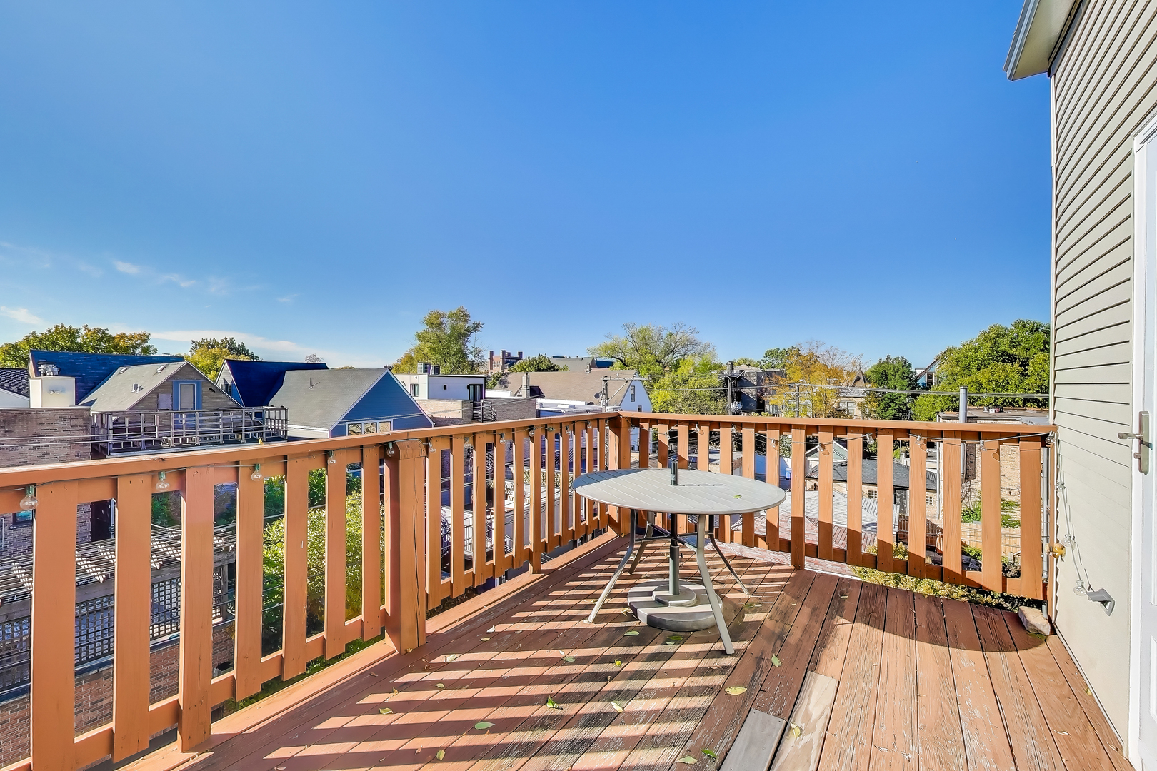1447 West Warner Avenue, Unit 3W Chicago, IL 60613 - Photo 24 of 27 a view of balcony with wooden floor and fence