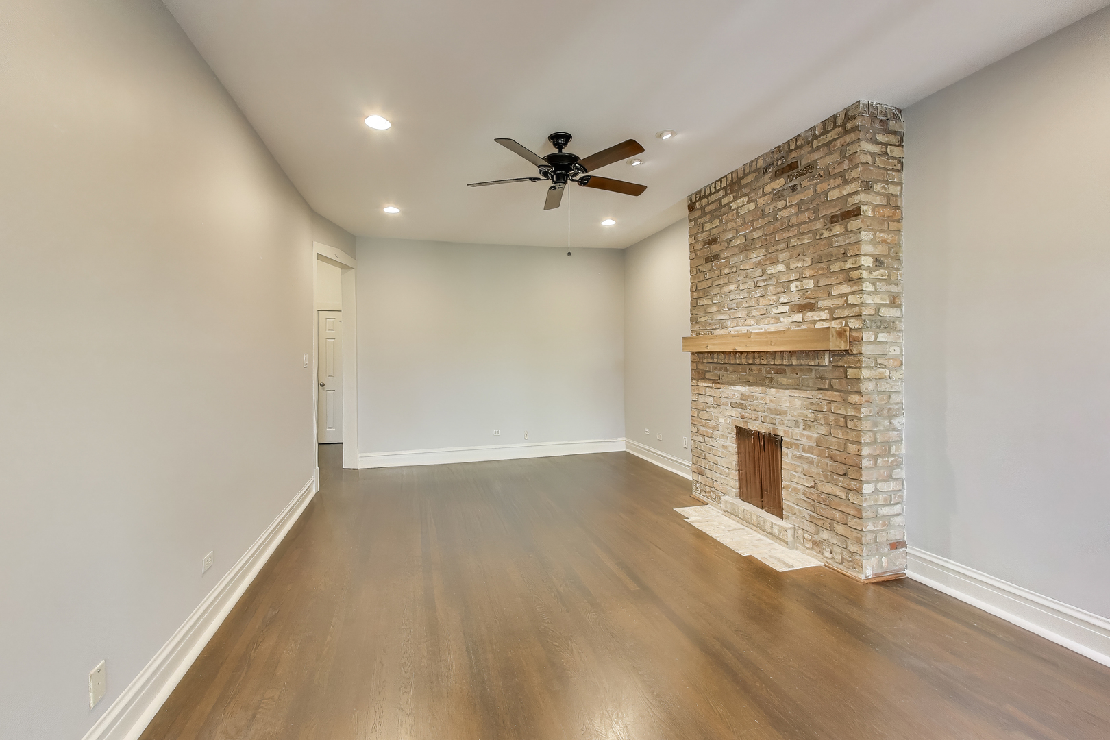1447 West Warner Avenue, Unit 3W Chicago, IL 60613 - Photo 4 of 27 an empty room with windows and fireplace