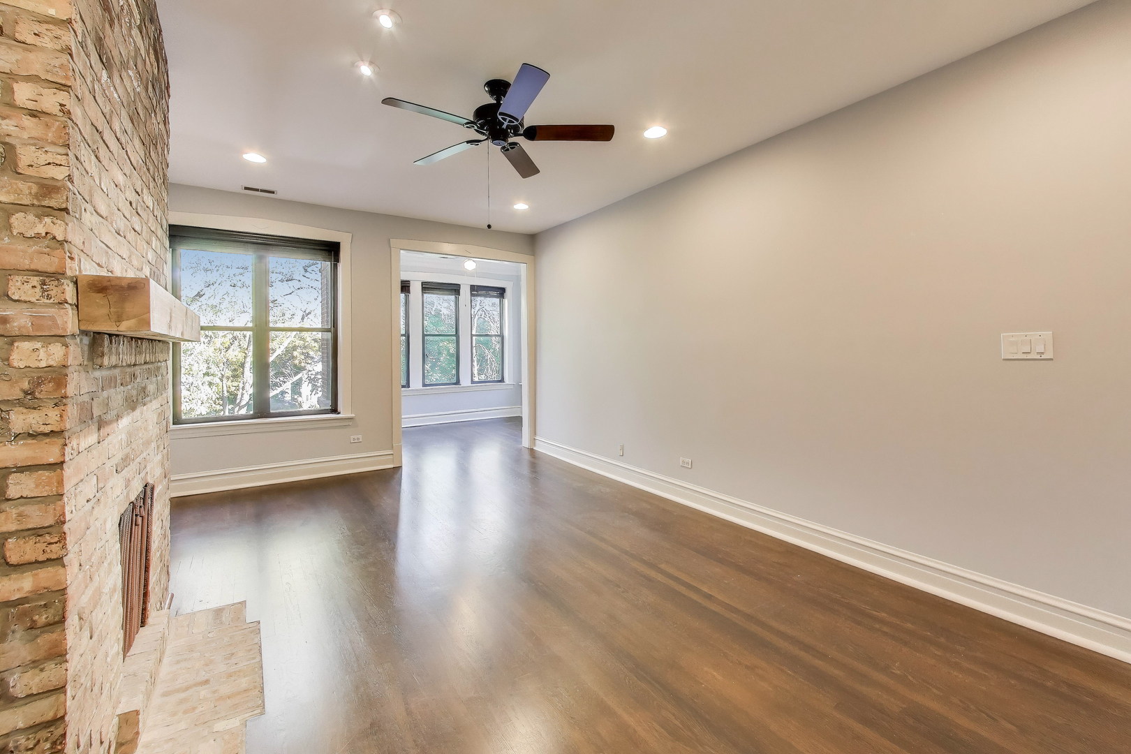 1447 West Warner Avenue, Unit 3W Chicago, IL 60613 - Photo 5 of 27 a view of an empty room with a window and wooden floor