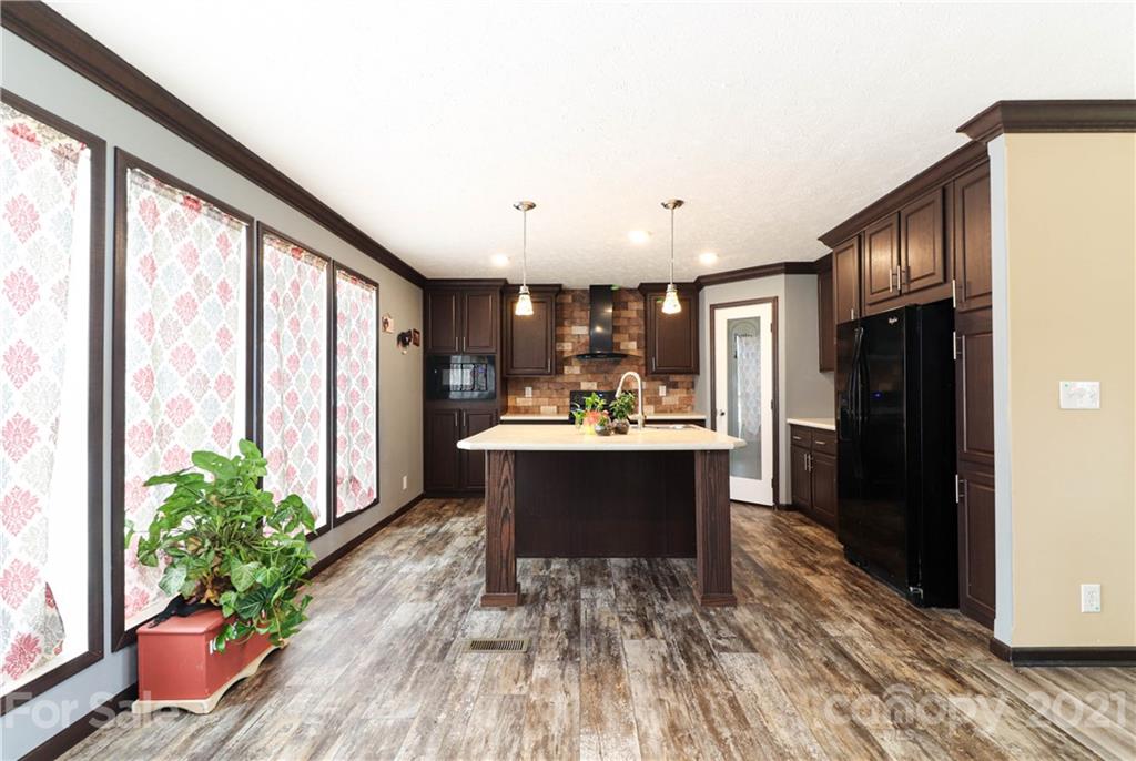 4024 Steen Road Mount Croghan, SC 29727 - Photo 15 of 37 a view of living room kitchen with furniture and wooden floor