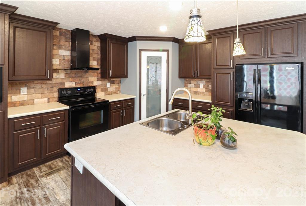 4024 Steen Road Mount Croghan, SC 29727 - Photo 17 of 37 a kitchen with a sink a stove and chairs