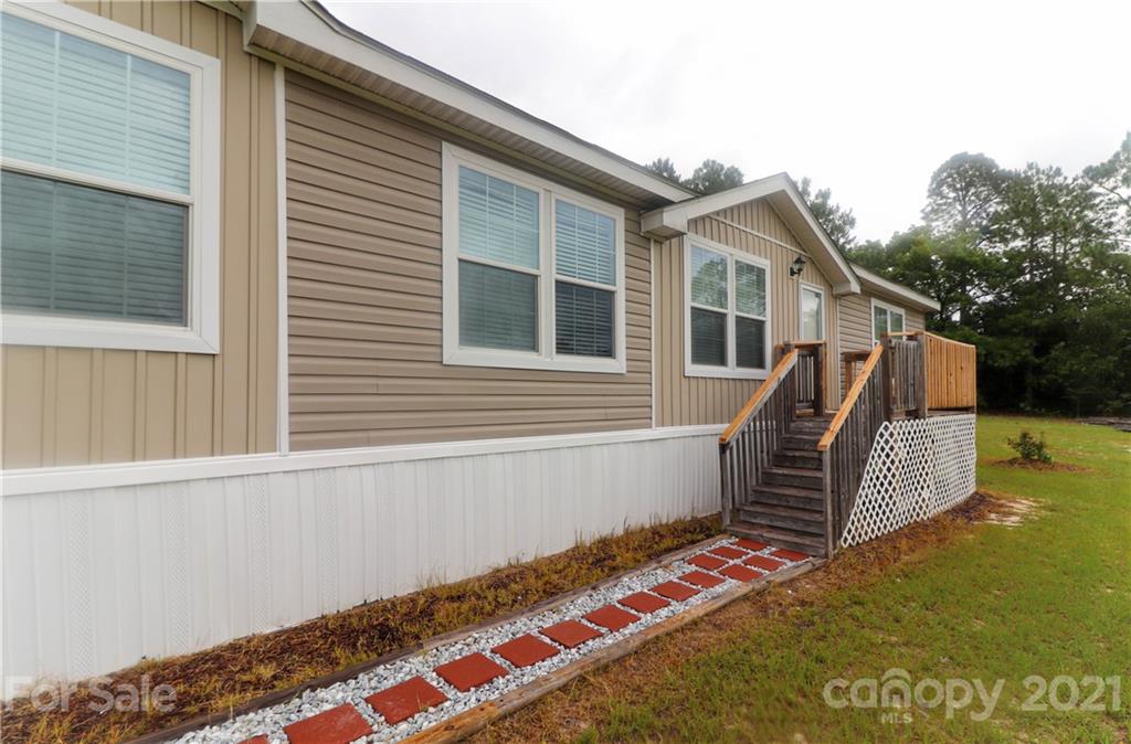 4024 Steen Road Mount Croghan, SC 29727 - Photo 3 of 37 a front view of house with yard slide and trees