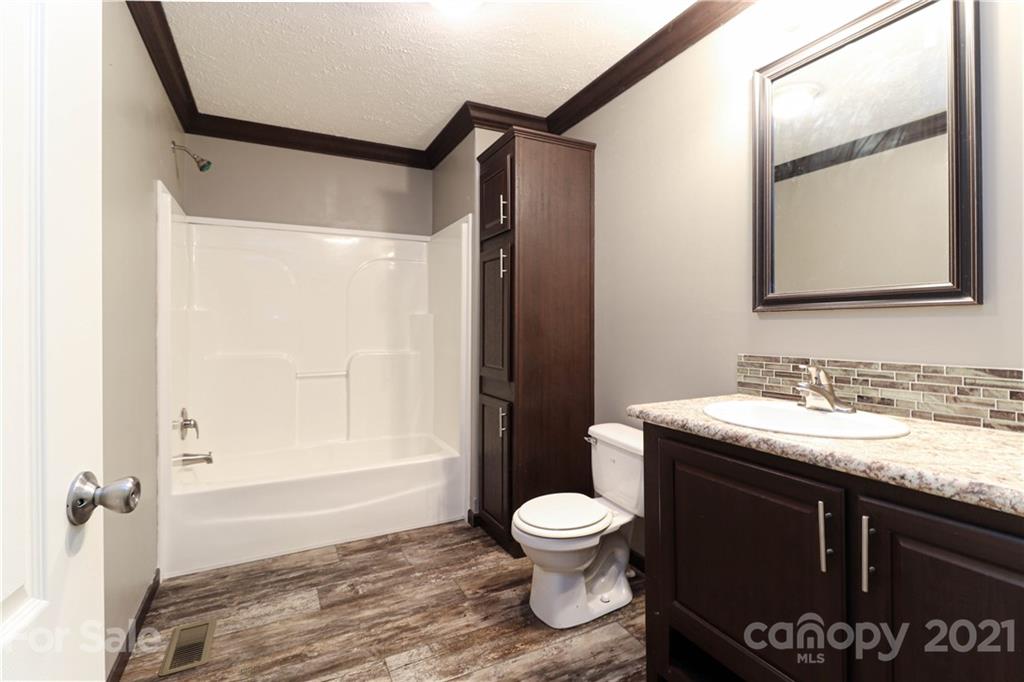 4024 Steen Road Mount Croghan, SC 29727 - Photo 22 of 37 a bathroom with a granite countertop sink toilet and shower