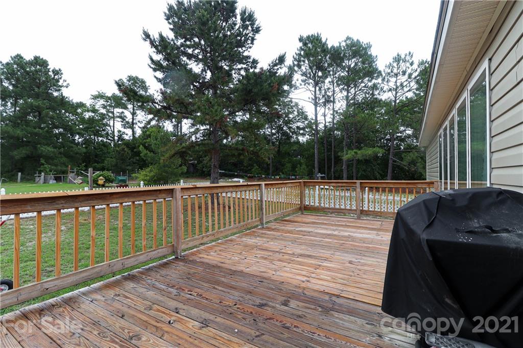 4024 Steen Road Mount Croghan, SC 29727 - Photo 28 of 37 a view of deck with wooden floor and fence and trees