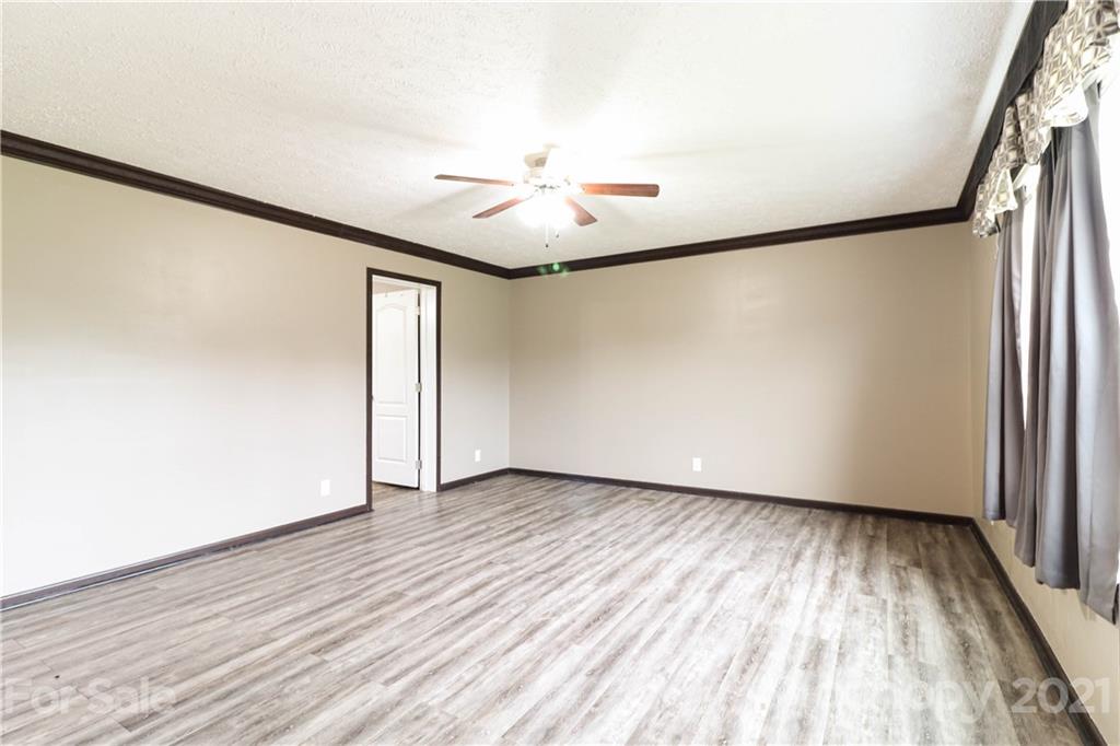 4024 Steen Road Mount Croghan, SC 29727 - Photo 5 of 37 a view of an empty room with wooden floor and a window