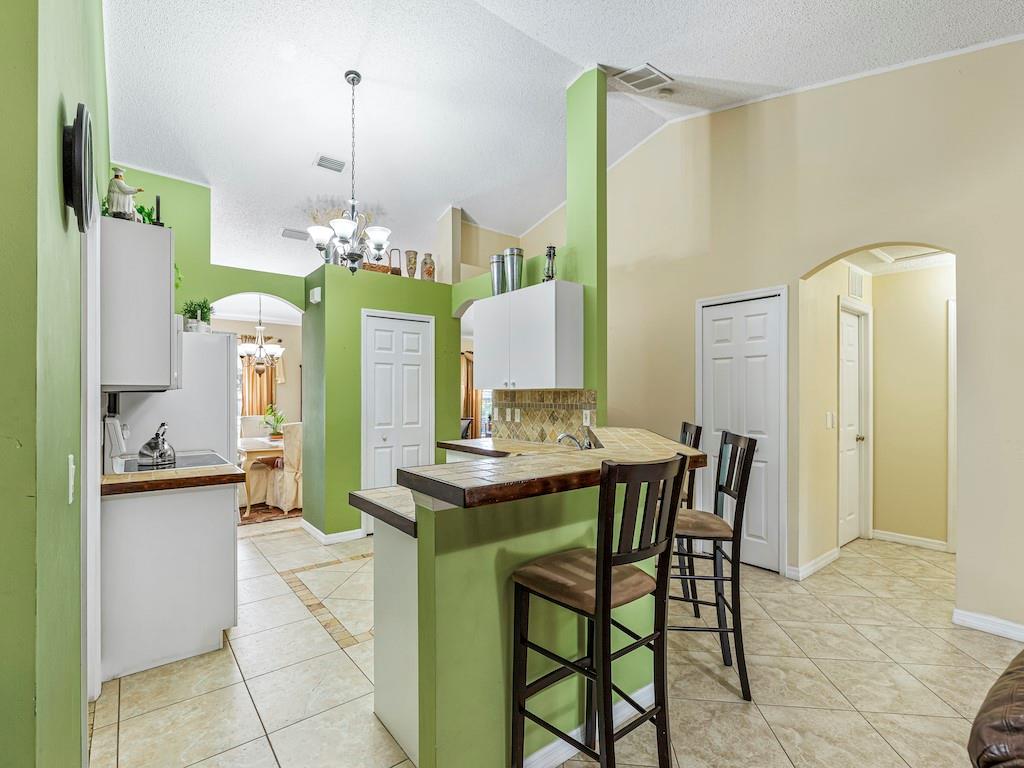 941 Southwest Longfellow Road Port St. Lucie, FL 34953 - Photo 8 of 36 a view of a dining room with furniture and chandelier