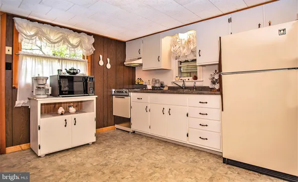 a kitchen with stainless steel appliances a refrigerator sink and stove