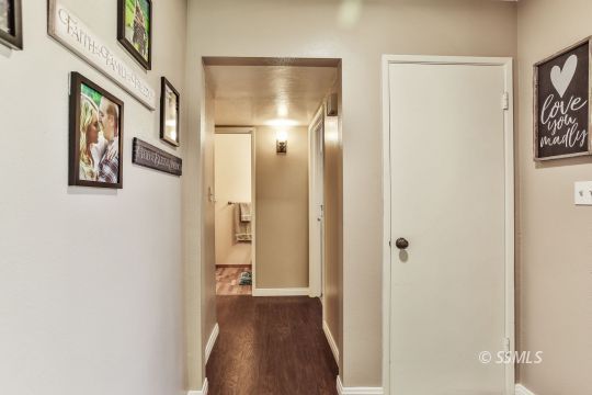 1023 North Norma Street Ridgecrest, CA 93555 - Photo 19 of 32 a view of a hallway with wooden floor and closet