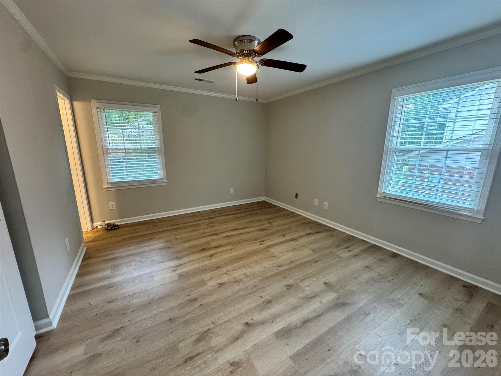 6314 Harrisburg Road Charlotte, NC 28227 - Photo 12 of 16 a view of an empty room with wooden floor and a window