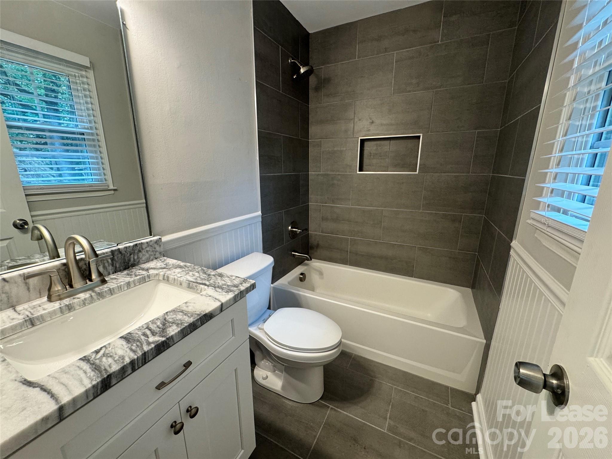 6314 Harrisburg Road Charlotte, NC 28227 - Photo 13 of 16 a bathroom with a granite countertop sink toilet and shower