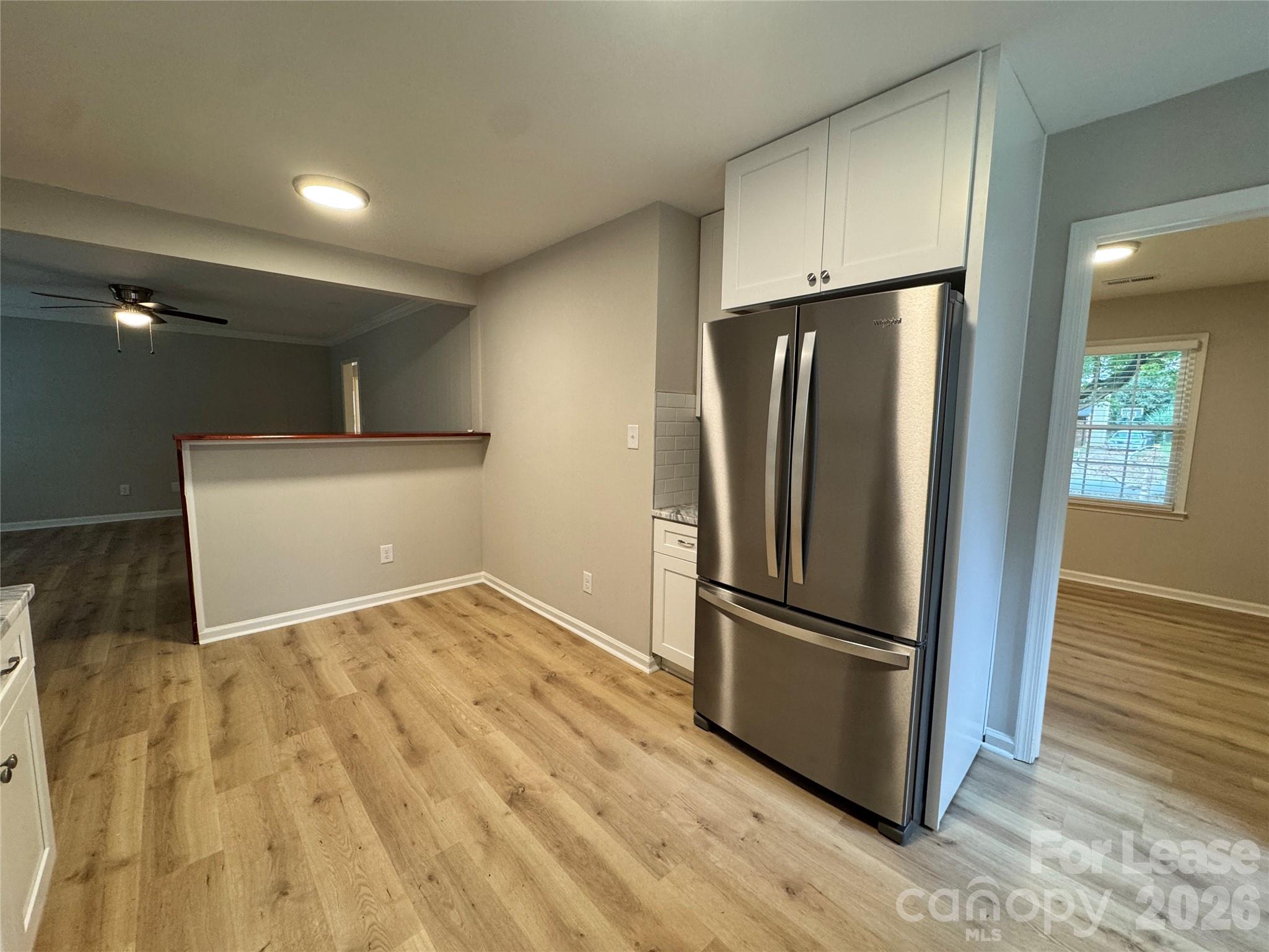 6314 Harrisburg Road Charlotte, NC 28227 - Photo 5 of 16 a view of a refrigerator in kitchen and wooden floor