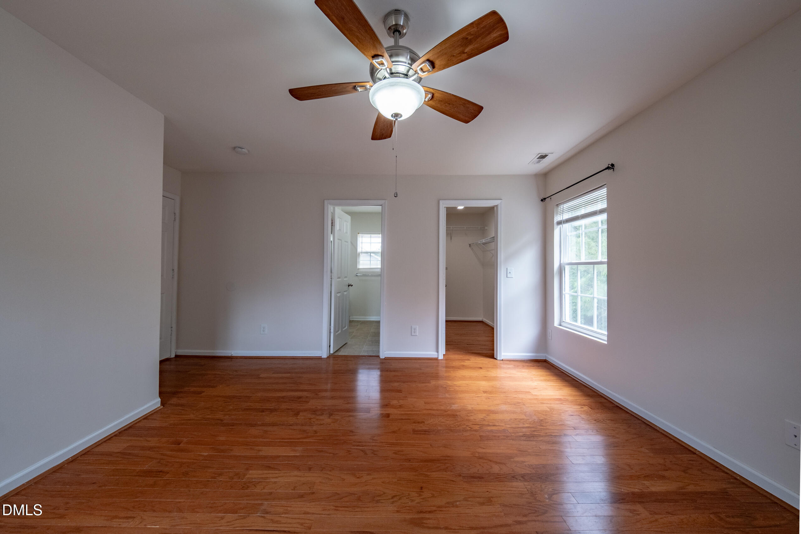 719 Obsidian Way Durham, NC 27703 - Photo 33 of 41 a view of an empty room with window and wooden floor