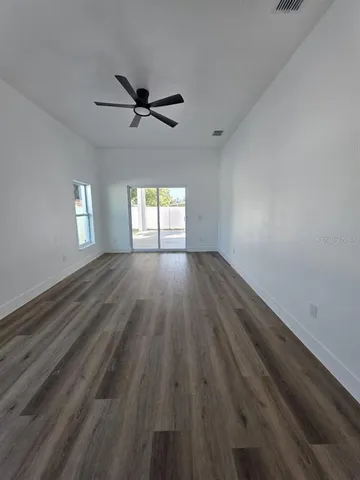 wooden floor in an empty room with a window