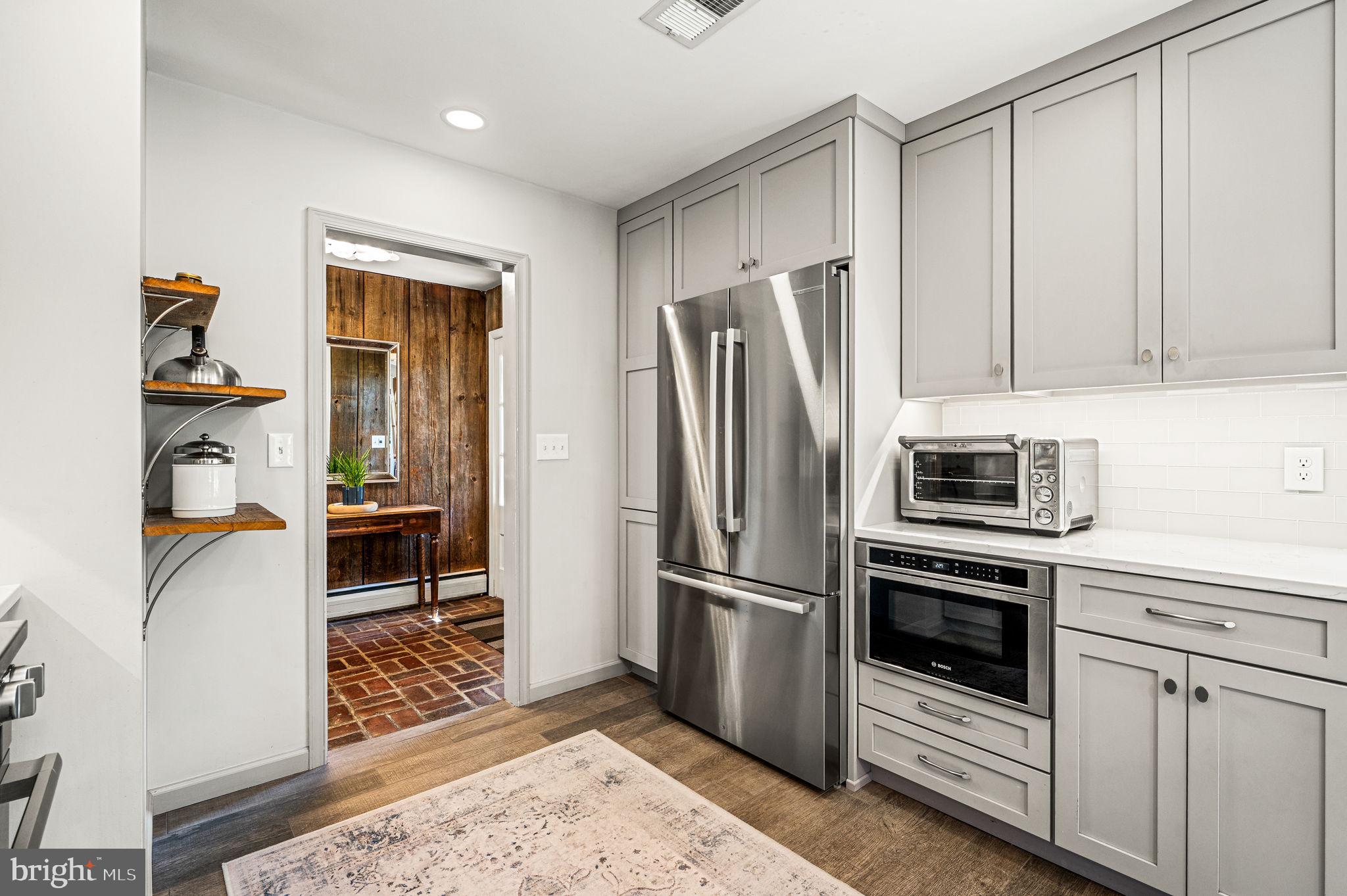 124 South Providence Road Wallingford, PA 19086 - Photo 15 of 53 a kitchen with stainless steel appliances a refrigerator sink and cabinets