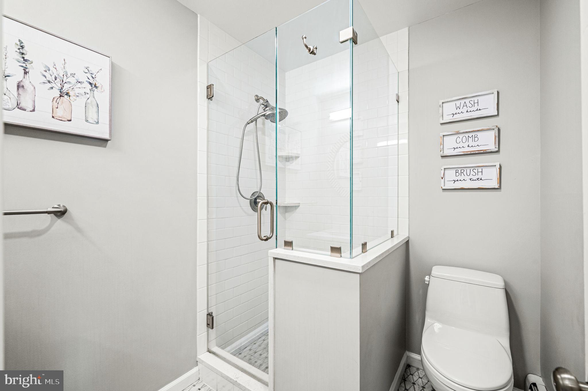 124 South Providence Road Wallingford, PA 19086 - Photo 20 of 53 a white toilet sitting next to a bathroom sink