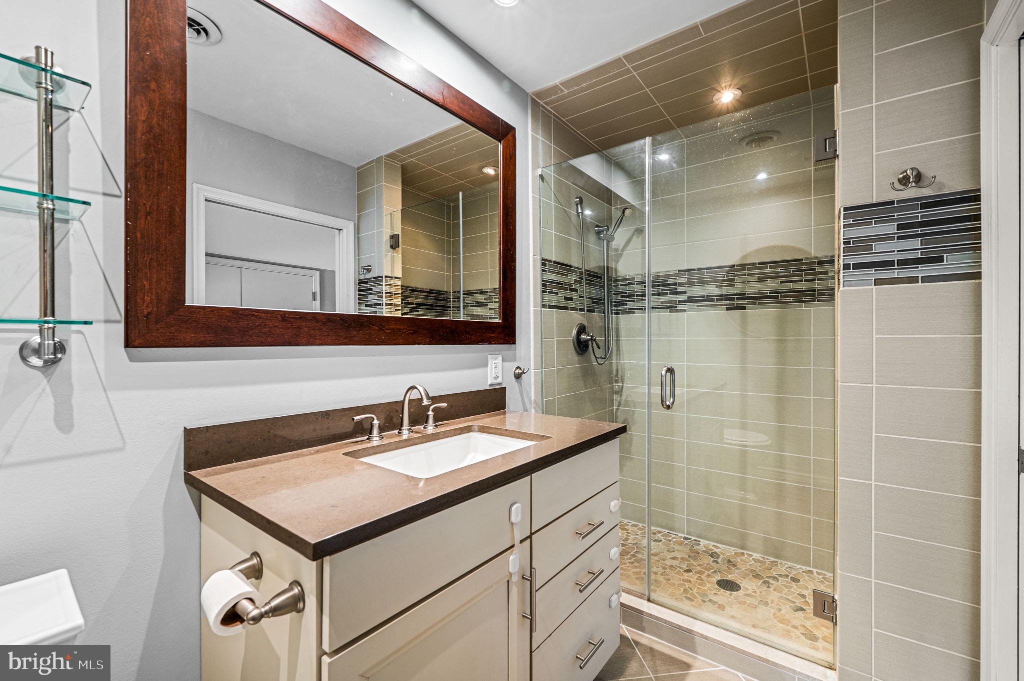 124 South Providence Road Wallingford, PA 19086 - Photo 26 of 53 a bathroom with a sink a toilet a mirror and shower