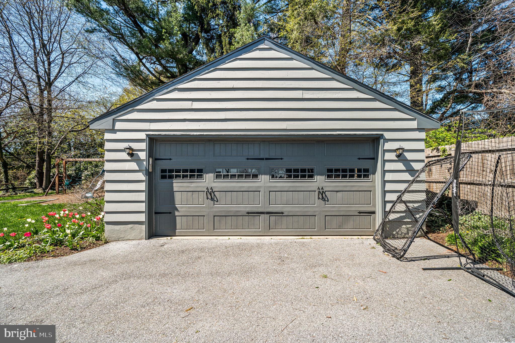 124 South Providence Road Wallingford, PA 19086 - Photo 42 of 53 a front view of a house with a yard and garage