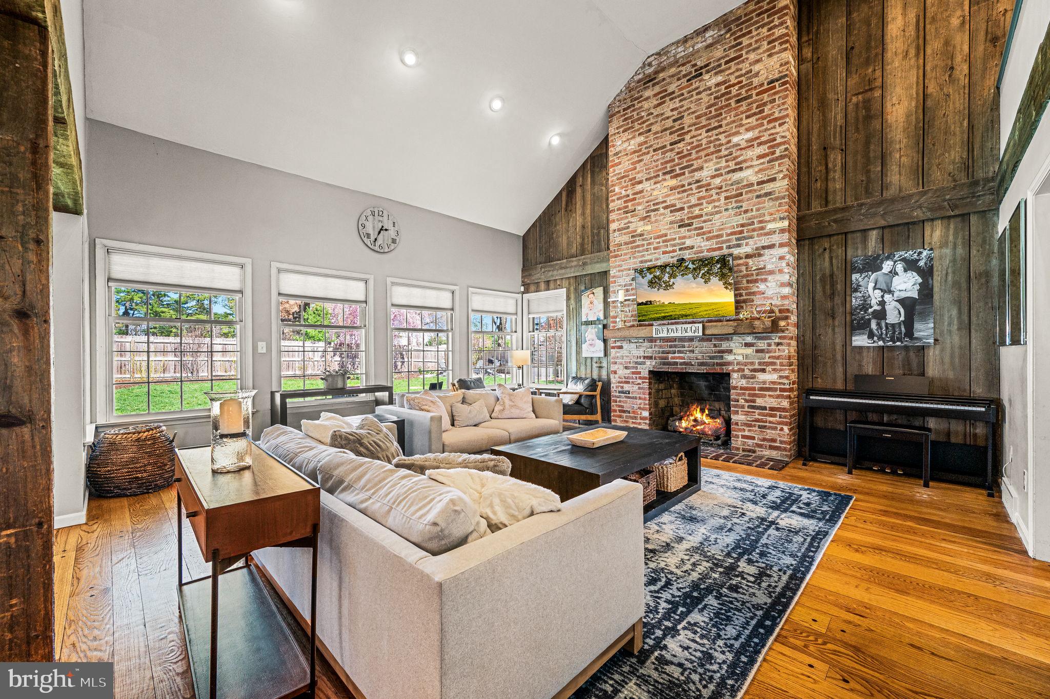 124 South Providence Road Wallingford, PA 19086 - Photo 7 of 53 a living room with furniture a fireplace and a floor to ceiling window