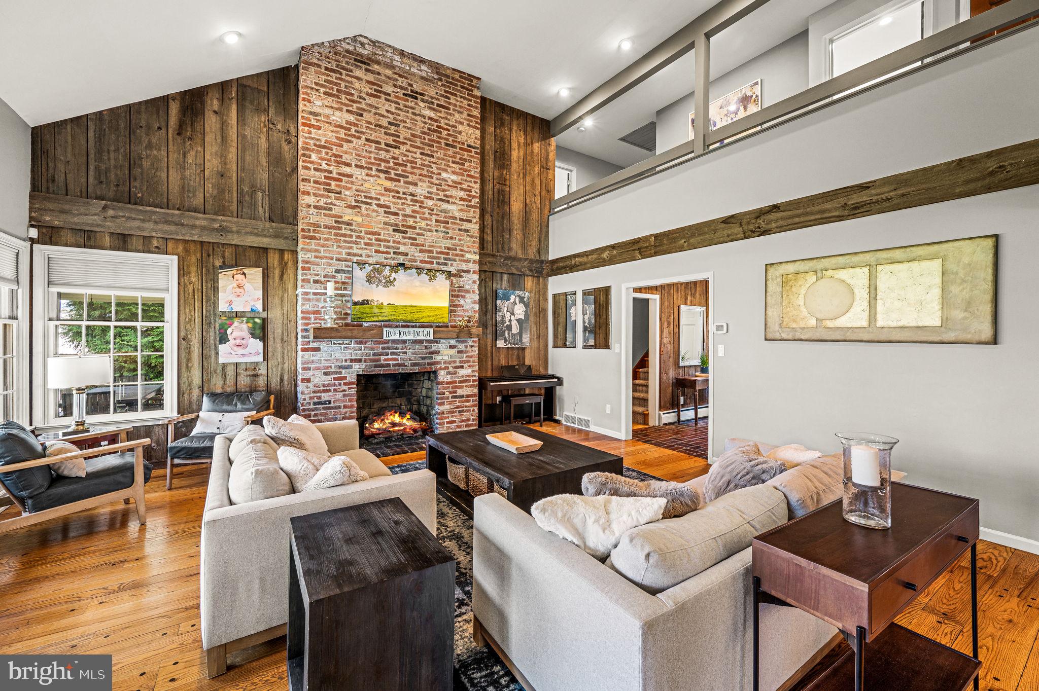 124 South Providence Road Wallingford, PA 19086 - Photo 8 of 53 a living room with furniture a fireplace and a large window