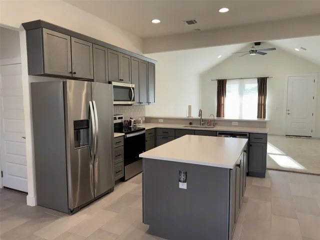 a kitchen with stainless steel appliances a refrigerator and a sink