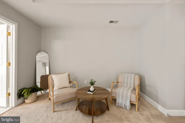 a bedroom with furniture and a large window