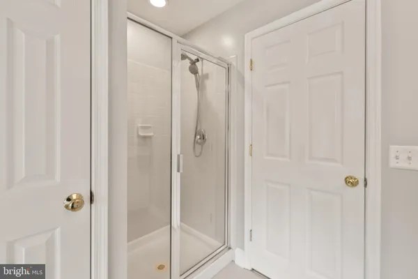 a bathroom with a bathtub sink and mirror